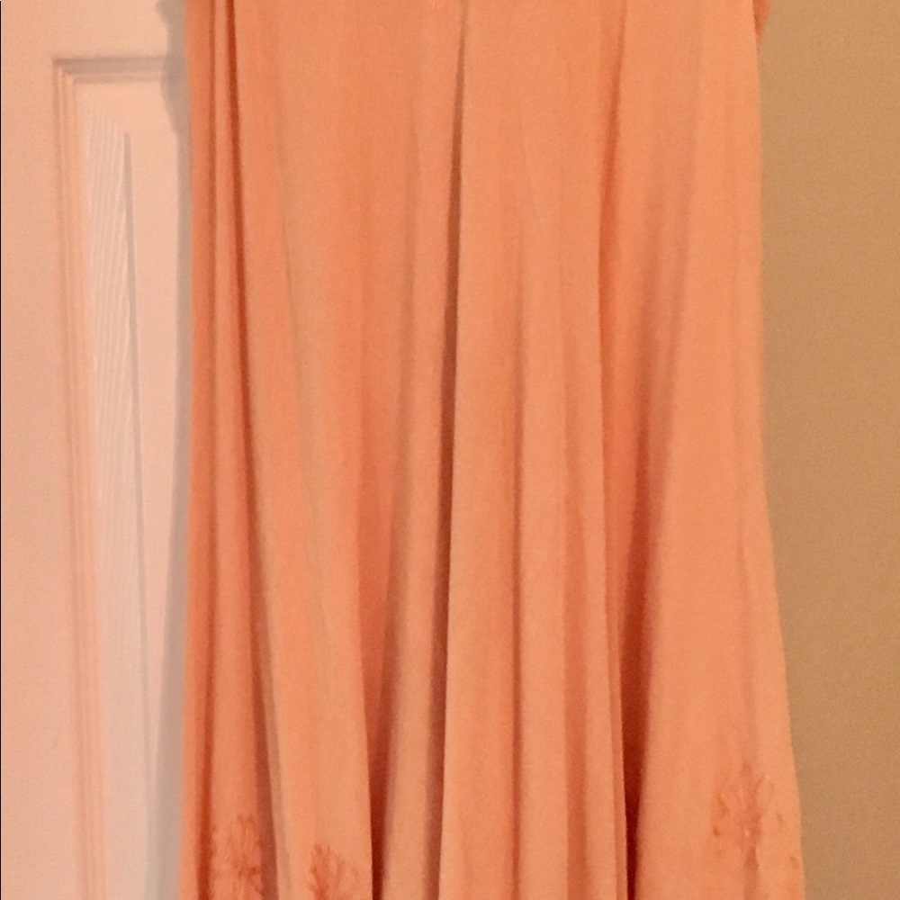 Flowing Peach dress with floral designs.